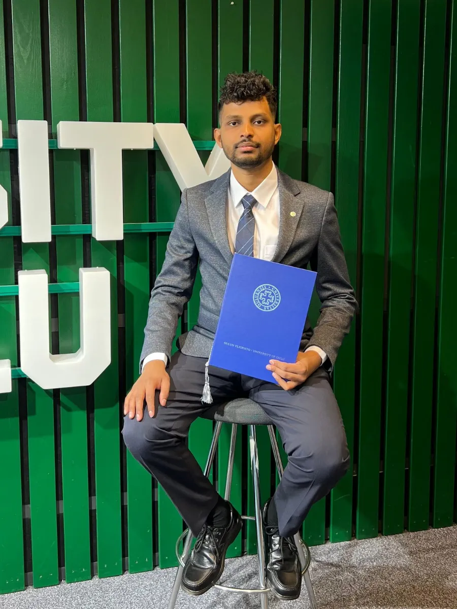 Kavindu Ravishan Perera at his graduation from the University of Oulu, holding his degree certificate