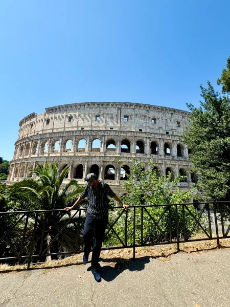 Kavindu Ravishan Perera in front of the Colosseum in Rome on a clear day